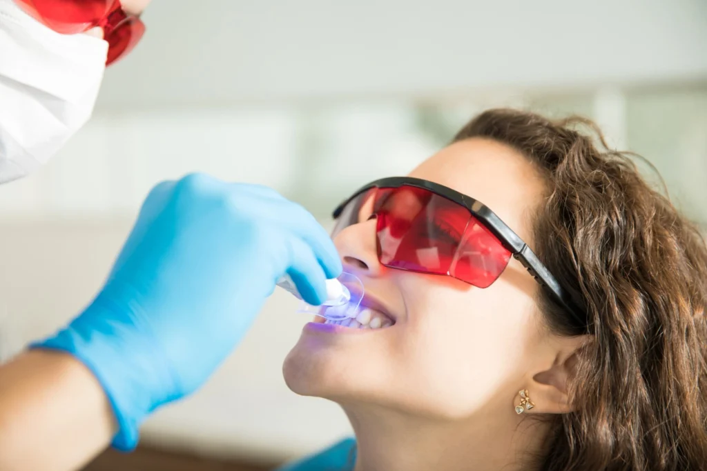 closeup-young-woman-having-her-teeth-whitened-with-ultraviolet-light-dental-clinic-1-2-scaled