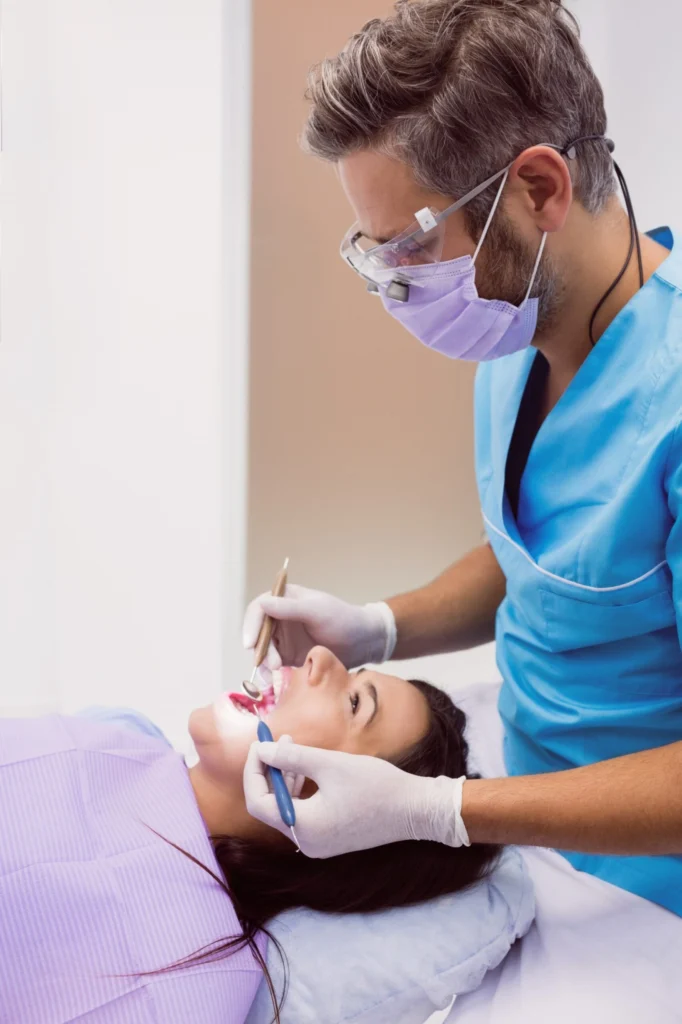 dentist-examining-female-patient-with-tools-1-1-1-scaled
